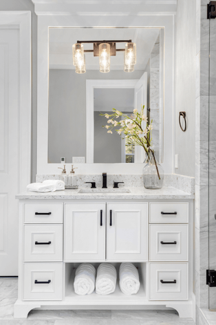 Gray and white vanity with large mirror and classic light fixture