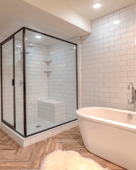 Shower and bathtub area with crossed tile flooring