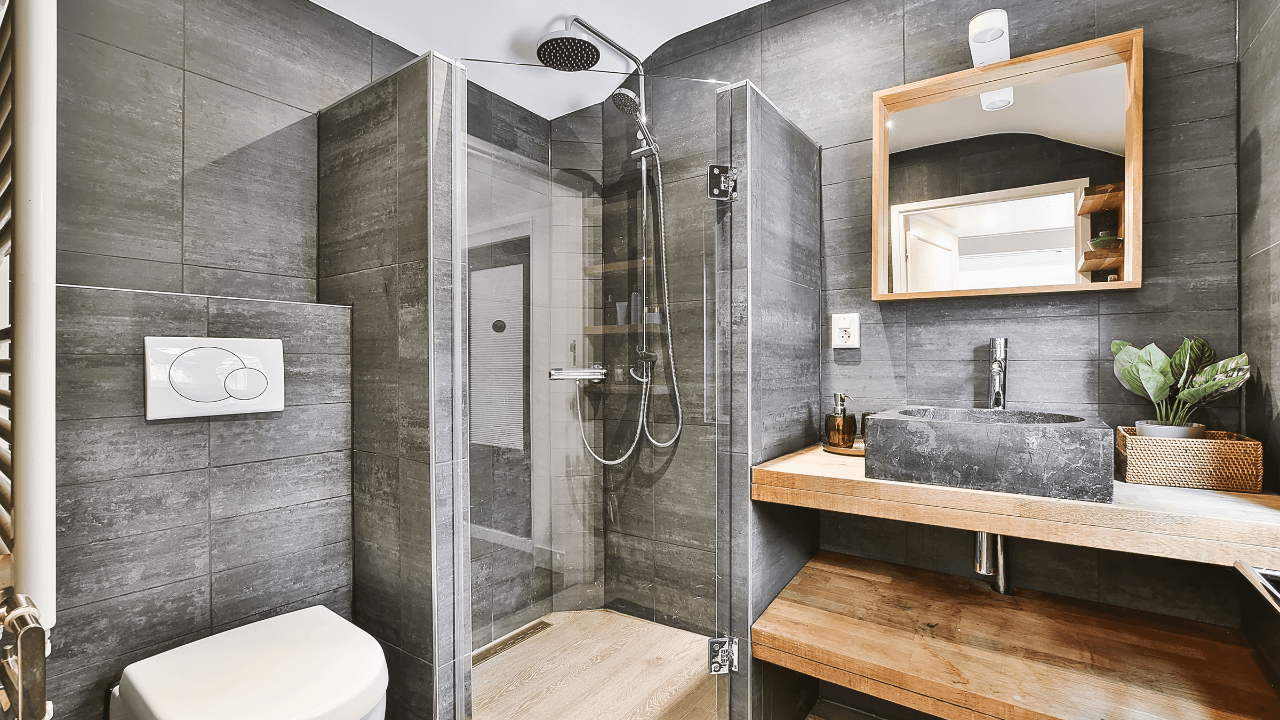 Stone-styled bathroom with corner shower equipped with waterfall shower head