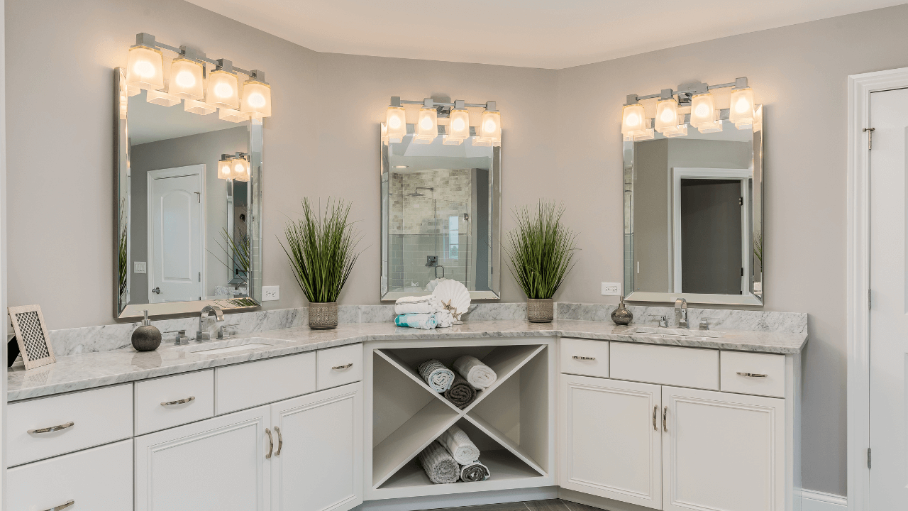 Wrap-around vanity area with 3 mirrors, 2 sinks, and many cabinets