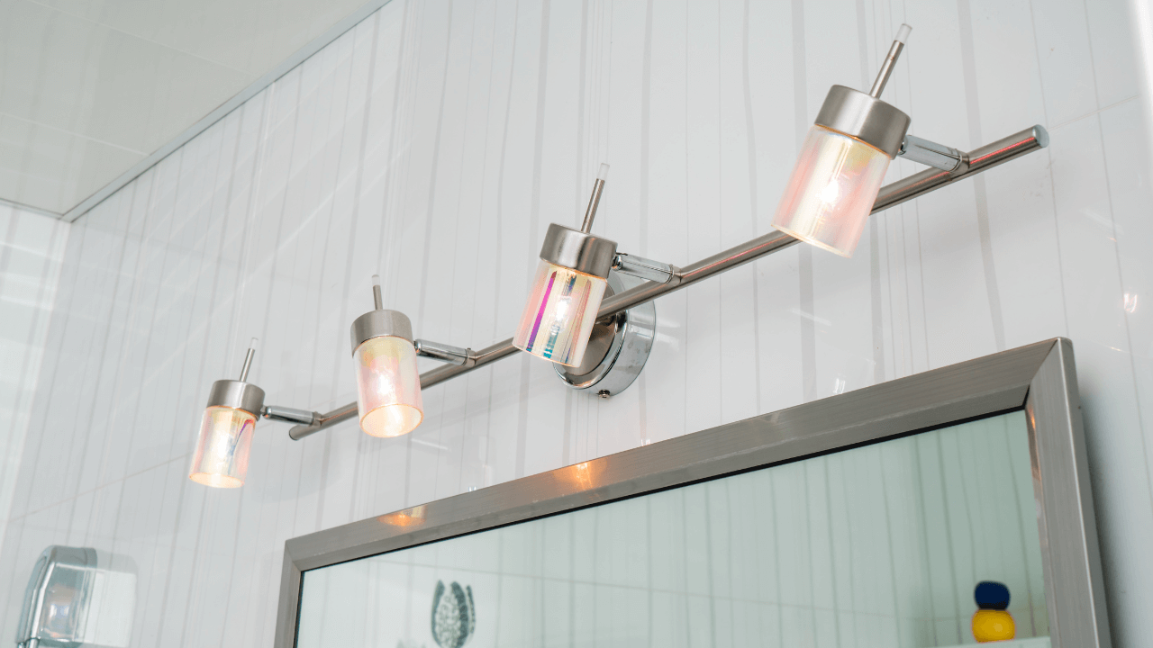 Long light fixture of 4 lightbulbs in bathroom